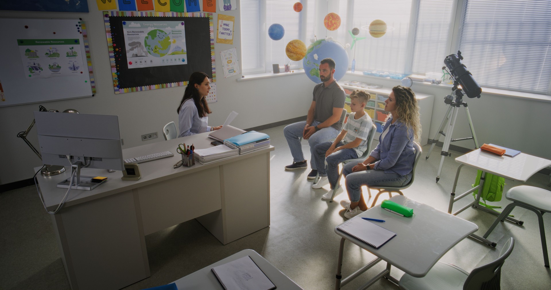 Teacher and Parents Discussing School Exam Results of Young Boy During Meeting